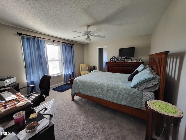 bedroom featuring ceiling fan, carpet floors, a textured ceiling, and baseboards