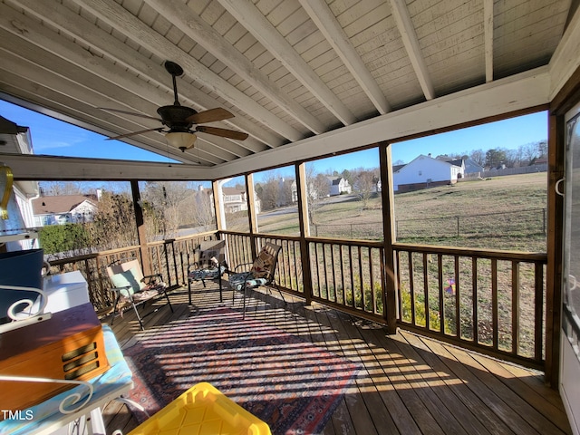 unfurnished sunroom with a ceiling fan, wood ceiling, and vaulted ceiling with beams