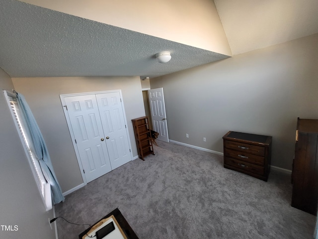 unfurnished bedroom featuring light carpet, a closet, baseboards, and a textured ceiling