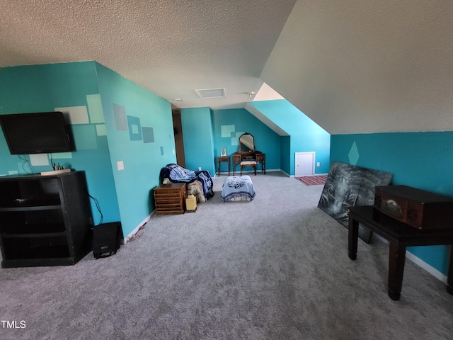 interior space with carpet flooring, vaulted ceiling, a textured ceiling, and baseboards