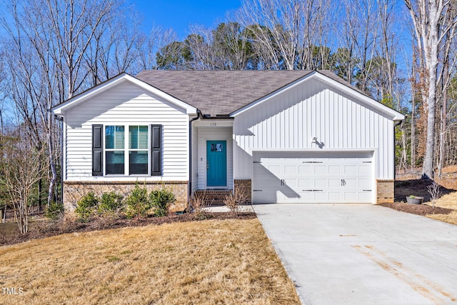 view of front of house featuring brick siding, a shingled roof, concrete driveway, an attached garage, and a front yard