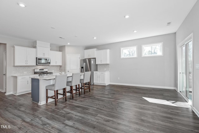 kitchen featuring white cabinetry, appliances with stainless steel finishes, and light countertops