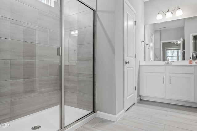 bathroom with a stall shower and vanity