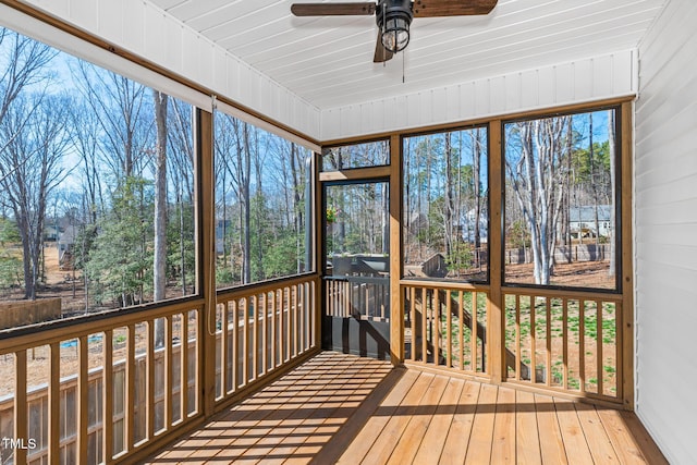 unfurnished sunroom with a ceiling fan