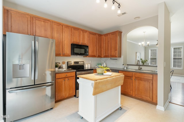 kitchen featuring tasteful backsplash, visible vents, butcher block counters, stainless steel appliances, and a sink