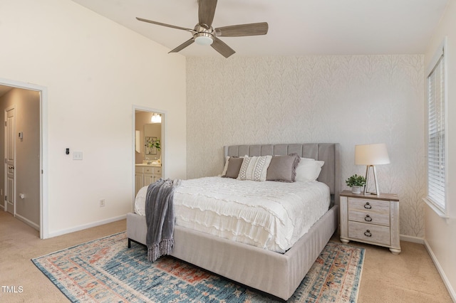 bedroom with connected bathroom, wallpapered walls, baseboards, carpet flooring, and a ceiling fan