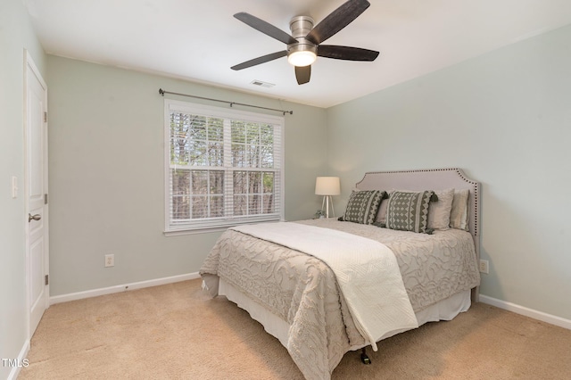 carpeted bedroom featuring visible vents, a ceiling fan, and baseboards