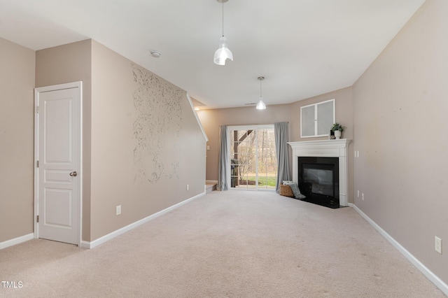 unfurnished living room with a fireplace with flush hearth, baseboards, and carpet floors