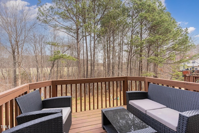 wooden terrace with an outdoor hangout area