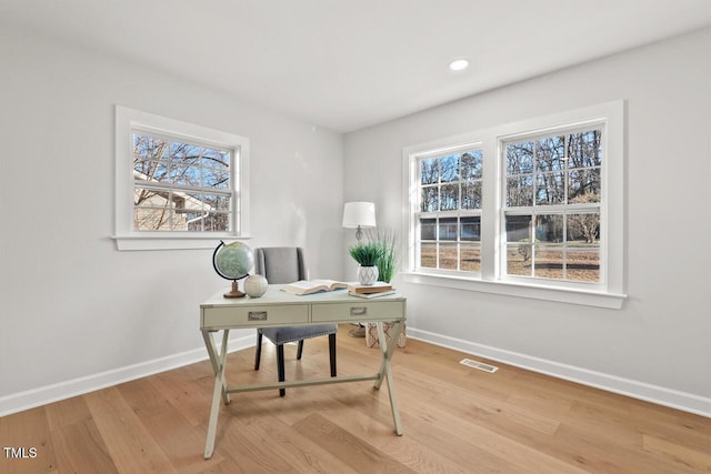 office area with light wood finished floors, recessed lighting, visible vents, and baseboards