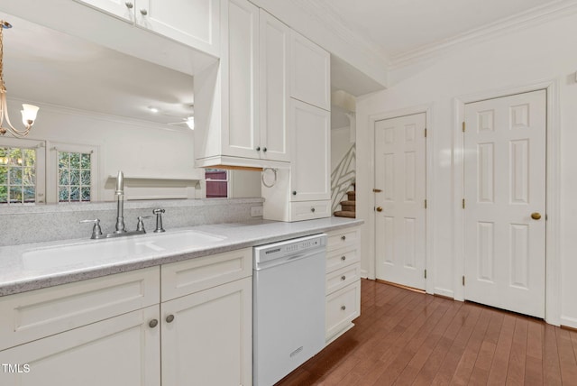 kitchen with ornamental molding, white cabinets, and white dishwasher