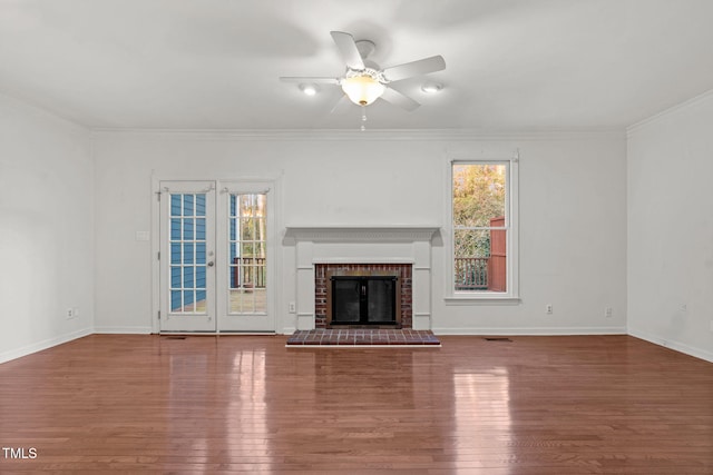 unfurnished living room with a wealth of natural light, a fireplace, and wood finished floors