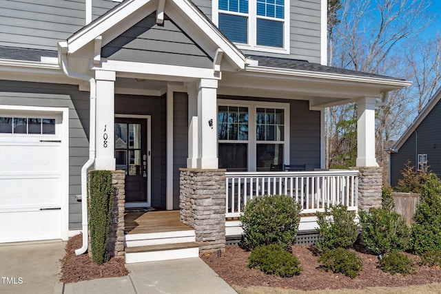 doorway to property featuring a porch, roof with shingles, and a garage