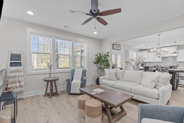 living area featuring light wood-type flooring, visible vents, baseboards, and recessed lighting