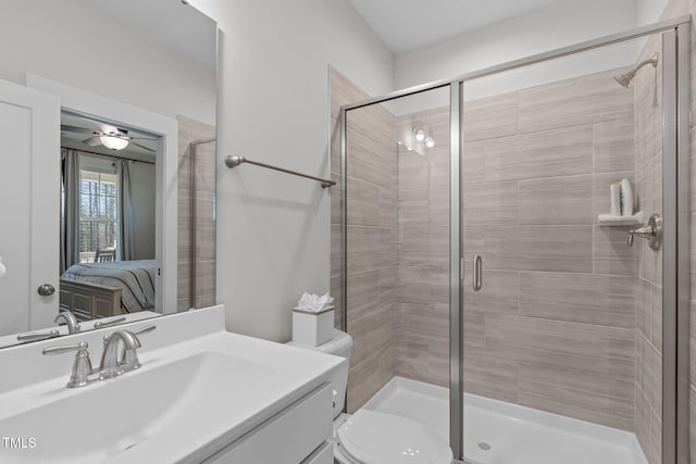 ensuite bathroom featuring toilet, a shower stall, ensuite bath, and vanity