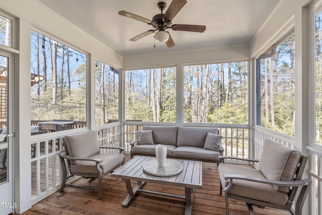 sunroom / solarium featuring plenty of natural light and ceiling fan