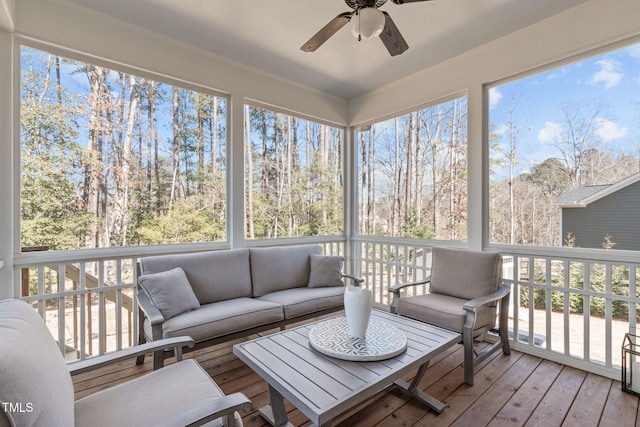 sunroom / solarium with a ceiling fan