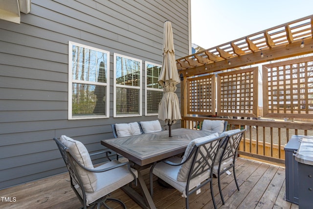 wooden deck with a pergola and outdoor dining space