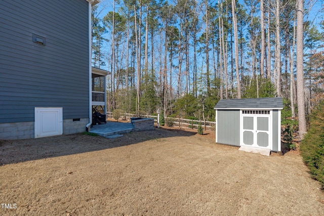 view of yard featuring an outbuilding, fence, and a shed