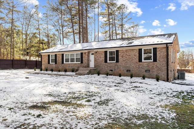 ranch-style house featuring central AC, brick siding, crawl space, and fence