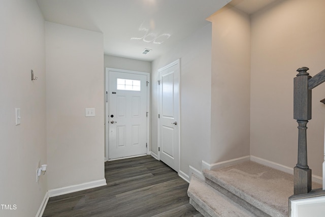 entrance foyer with stairs, baseboards, and dark wood-type flooring