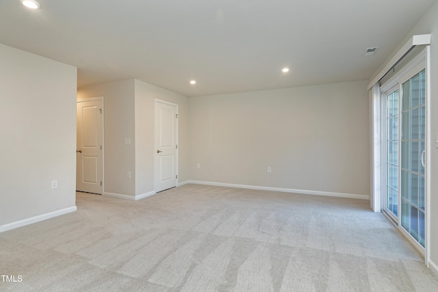 spare room with light carpet, visible vents, baseboards, and recessed lighting