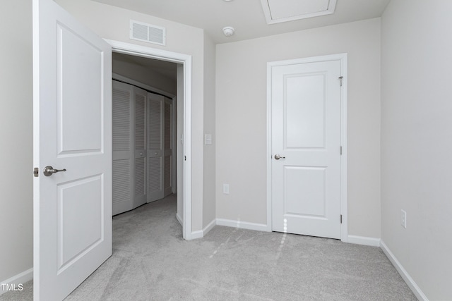 unfurnished bedroom with light carpet, baseboards, and visible vents