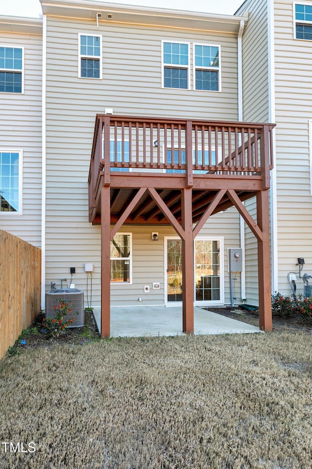 back of property with a patio, central AC unit, a lawn, and fence