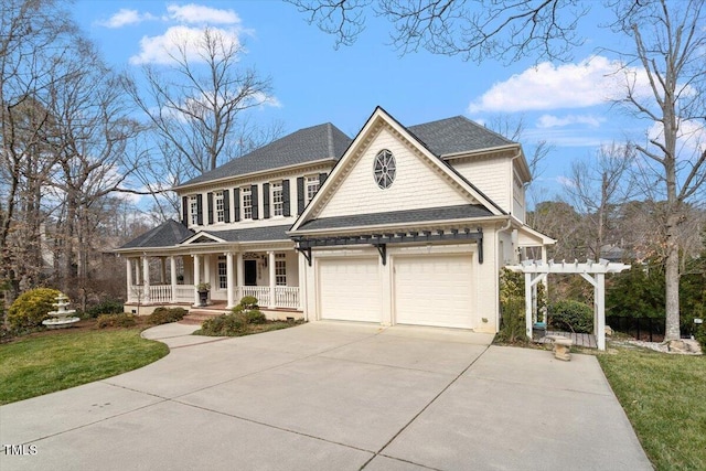 view of front of property with a garage, a pergola, a porch, and concrete driveway