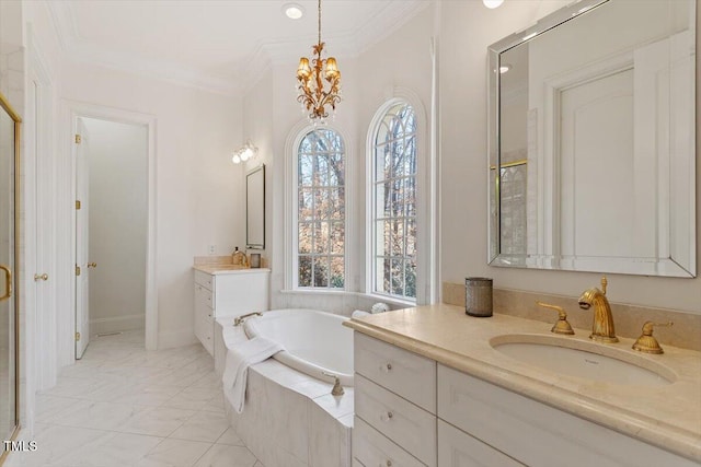 full bath with ornamental molding, two vanities, a sink, a garden tub, and a notable chandelier