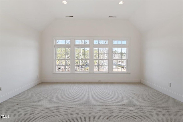 empty room featuring light carpet, visible vents, vaulted ceiling, and recessed lighting