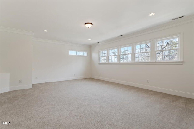 empty room featuring ornamental molding, visible vents, and light carpet