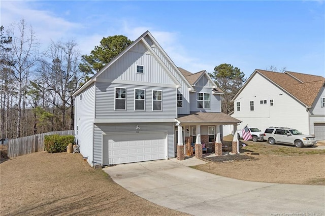 view of front of home with a porch, a garage, fence, concrete driveway, and board and batten siding