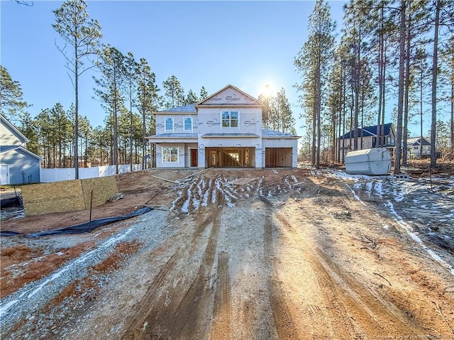 unfinished property featuring driveway and fence