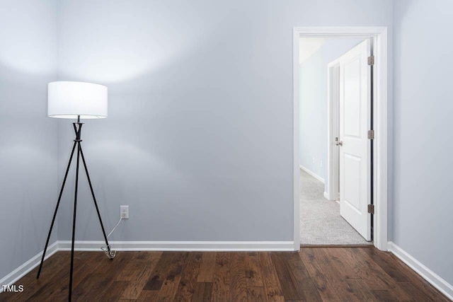 interior space featuring baseboards and wood finished floors