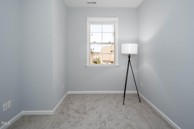 unfurnished room with visible vents, carpet, and baseboards