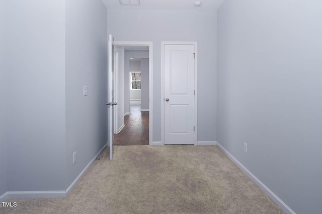 carpeted spare room with baseboards