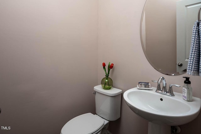 bathroom featuring toilet and a sink