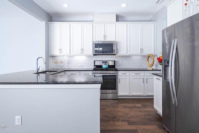 kitchen featuring a sink, stainless steel appliances, and white cabinetry