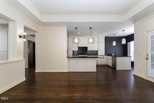 kitchen featuring white cabinetry, a peninsula, dark countertops, and dark wood-style flooring