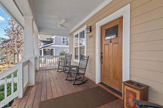 wooden deck featuring a porch and ceiling fan