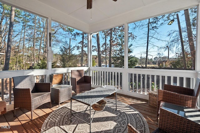 sunroom / solarium featuring a ceiling fan and a healthy amount of sunlight