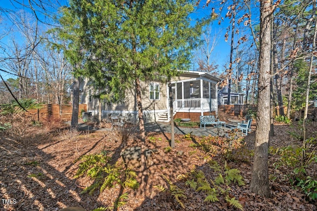 exterior space with a patio area and a sunroom