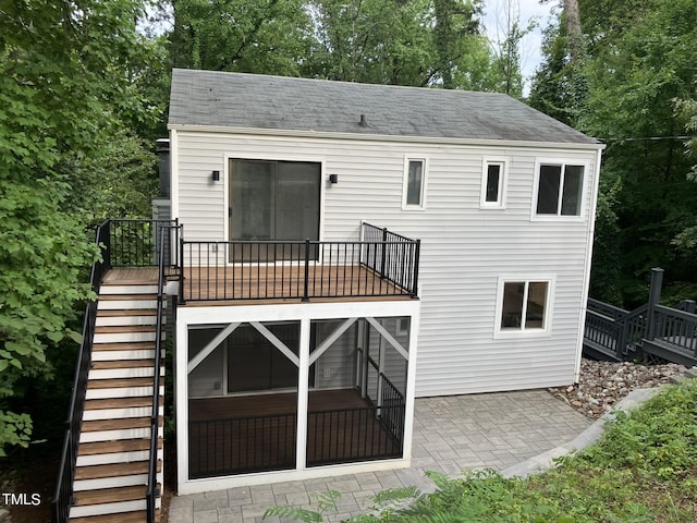 back of house featuring stairs