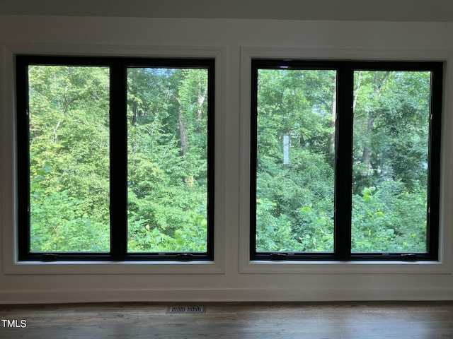 interior space with visible vents and wood finished floors