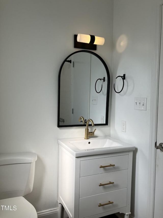 bathroom with toilet and vanity