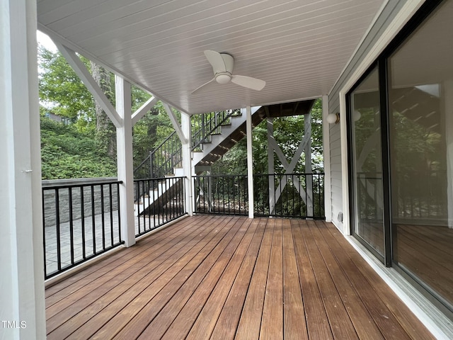 wooden terrace with ceiling fan and stairway