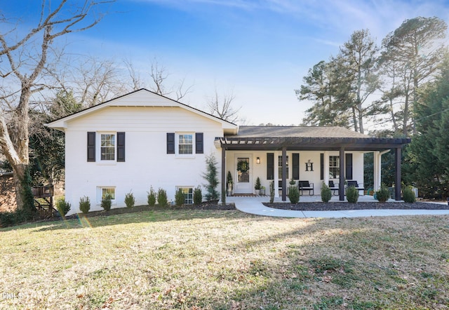 split level home with covered porch, brick siding, and a front lawn