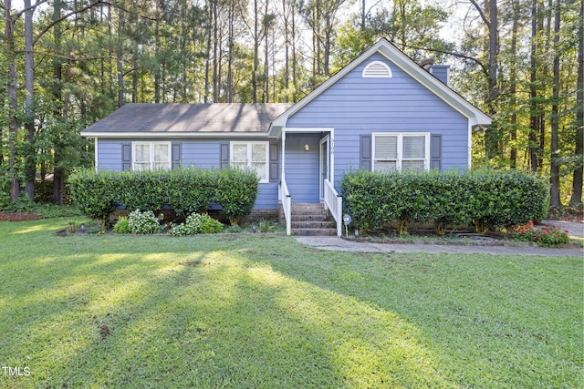 view of front of home featuring a front lawn and a chimney