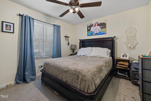 bedroom featuring light carpet, ceiling fan, and baseboards